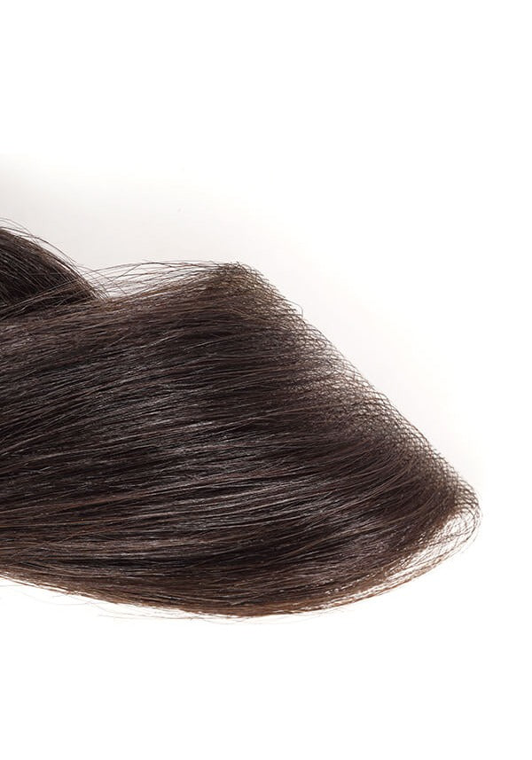 Close-up of a brown ReHair temple hair patch on a white background.